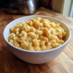 A white bowl filled with creamy 3 ingredient stovetop mac and cheese, showing elbow macaroni coated in a rich cheese sauce.