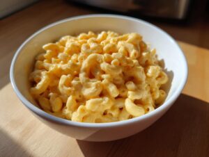 A bowl of creamy 3 ingredient stovetop mac and cheese, featuring elbow macaroni coated in a rich cheese sauce.