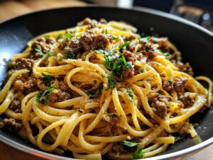 A close-up of a bowl filled with delicious Beef and Garlic Butter Linguine, garnished with fresh parsley.
