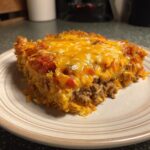 A hearty slice of Dorito Casserole with seasoned ground beef, crushed Doritos, and melted cheddar cheese.
