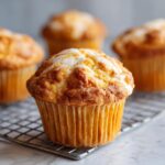 Close-up of a Starbucks Pumpkin Cream Cheese Muffin with a drizzle of cream cheese frosting.