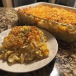 A generous serving of creamy tuna noodle casserole topped with melted cheese and breadcrumbs.